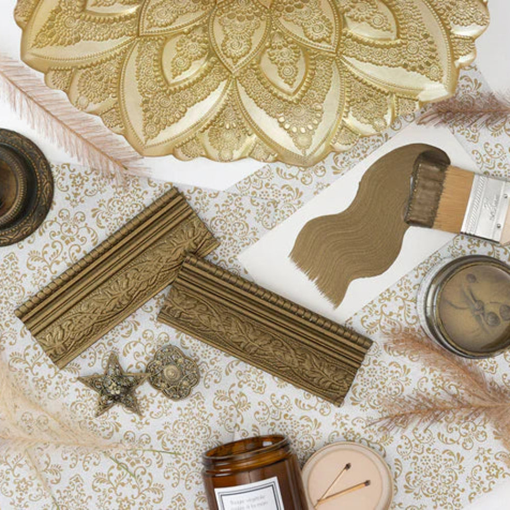 Decorative items including a paintbrush, decorative plates, and jars in Fusion Mineral Paints Metallic Bronze