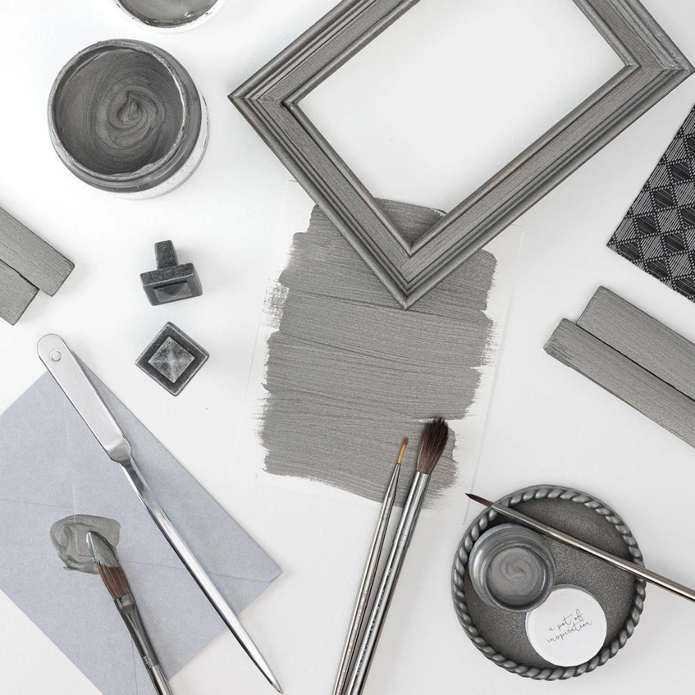 Collection of items including a frame, brushes, and containers painted in Fusion Metallics Brushed Steel on a white background