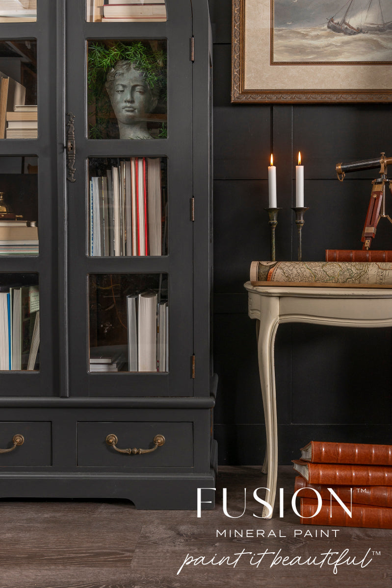 Dark grey cabinet painted in Cast Iron from Fusion Mineral Paint range, with books and decorative items
