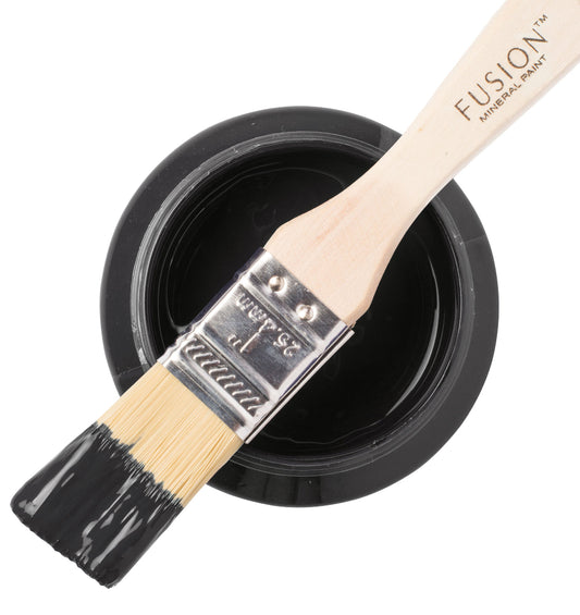 Paint brush with Cast Iron black paint and Fusion Mineral Paint container on a white background