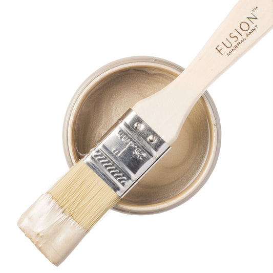 Paint brush with Champagne Gold Fusion Mineral Paint Metallics paint on a white background