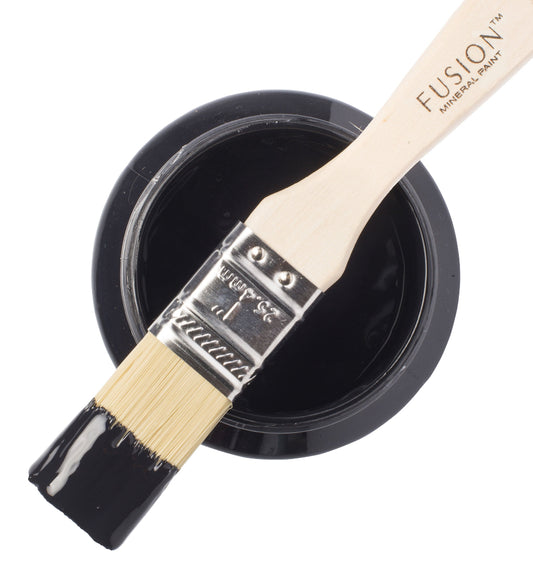 Fusion Mineral Paint brush with Coal Black paint sample on a white background