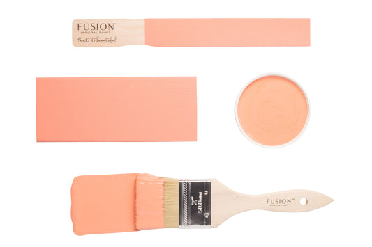 A paintbrush and colour samples of Coral Fusion Mineral Paint on a white background