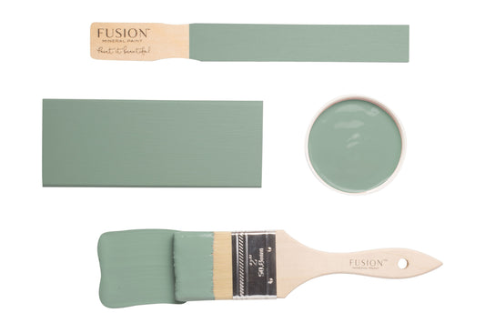 Paint brush and swatches with French Eggshell Fusion Mineral Paint on a white background