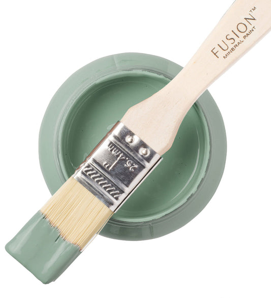 French Eggshell Fusion Mineral Paint in a container with a brush resting on the top