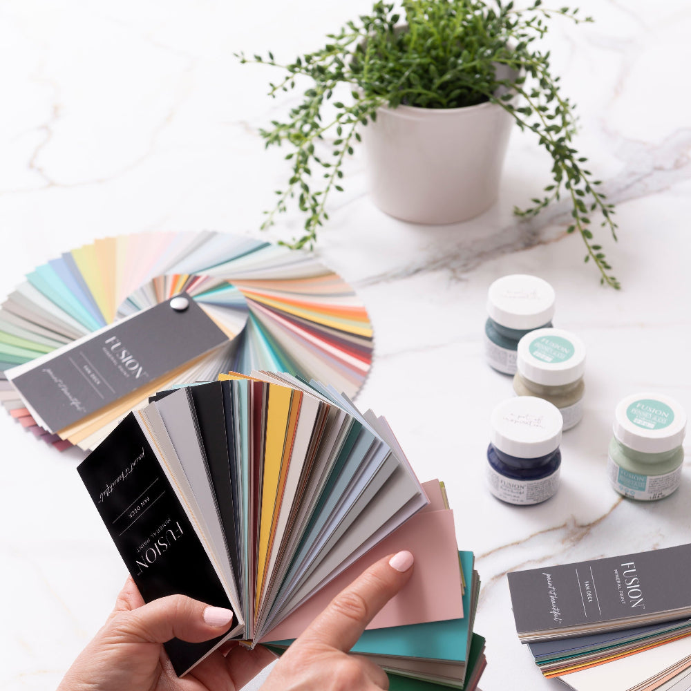 Person holding a colour swatch Fan Deck of Fusion Mineral Paint