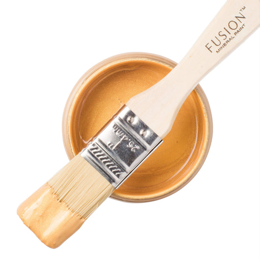 Gold Metallic Fusion Mineral Paint on  a brush resting on an open jar