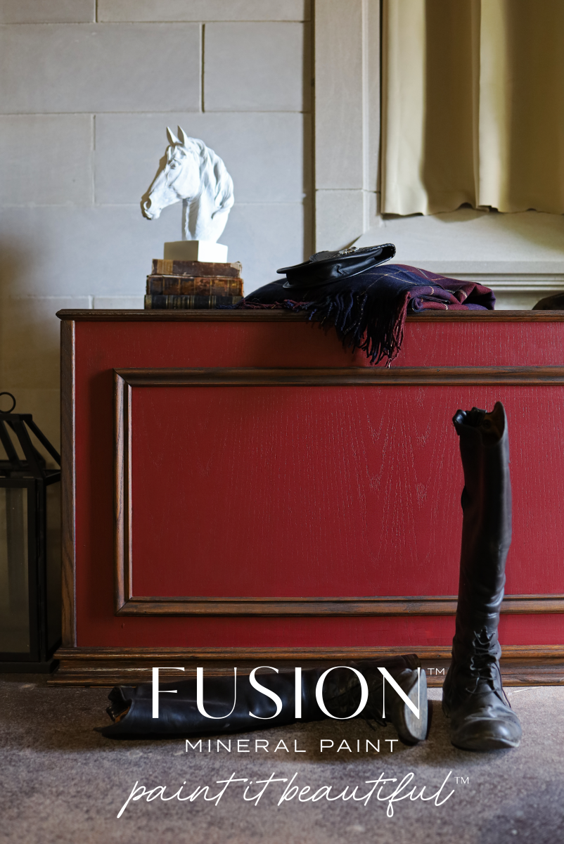 A cabinet painted in red Highlander from Fusion Mineral Paint range with a horse statue and riding boots