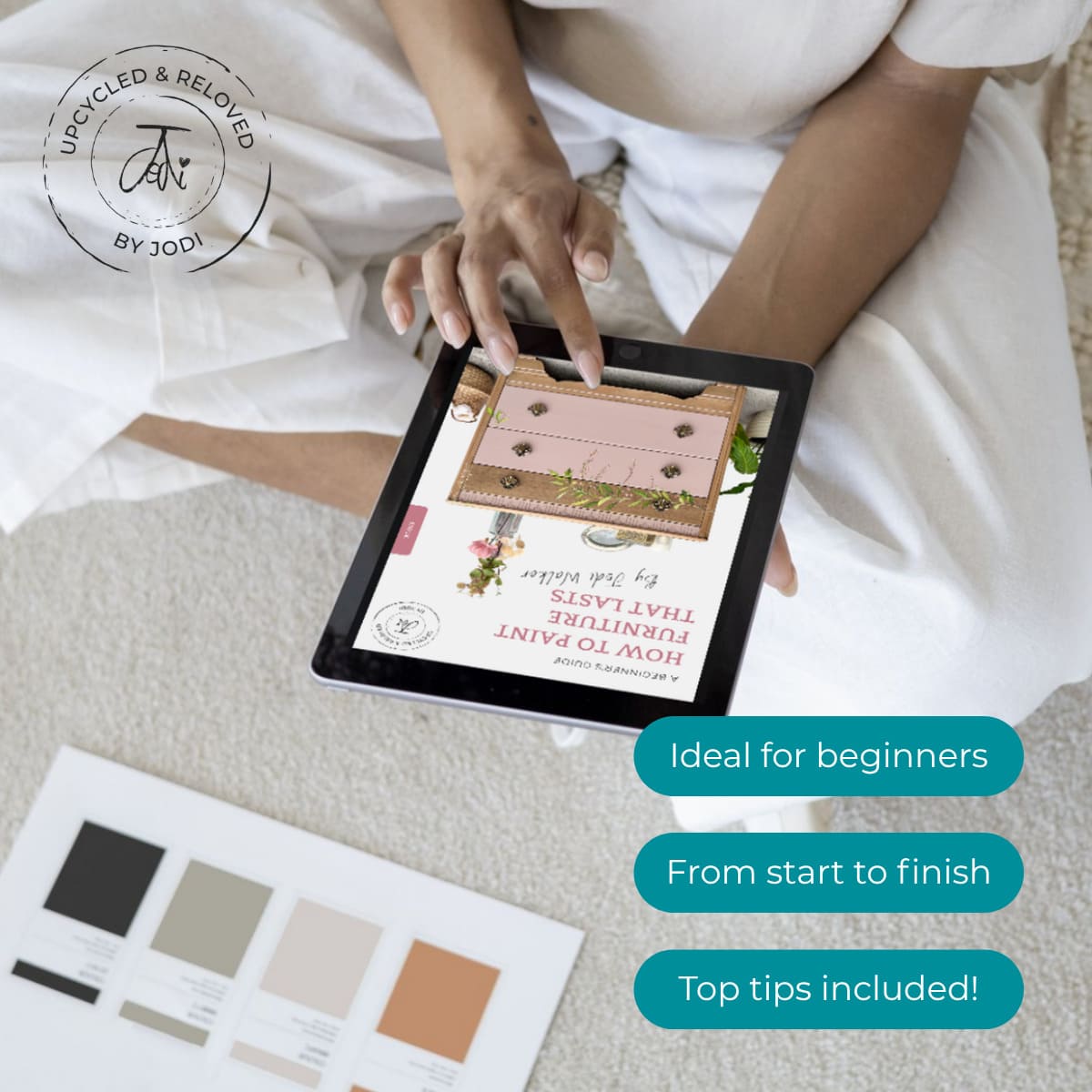 Person holding a tablet with a DIY upcycling furniture ebook called how to paint furniture that lasts, written by Upcycled & Reloved by Jodi