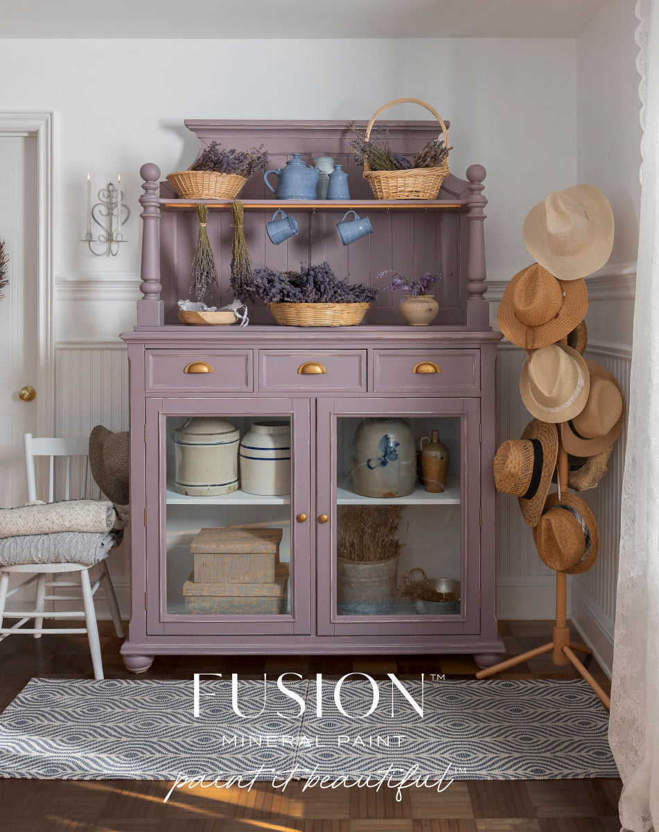 Hutch painted in Lavender Haze from Fusion Mineral Paint range with decorative items in a room with hats on a rack
