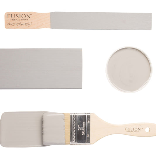 Paintbrush and colour swatch in wooly grey Little Lamb from Fusion Mineral Paint on a white background.