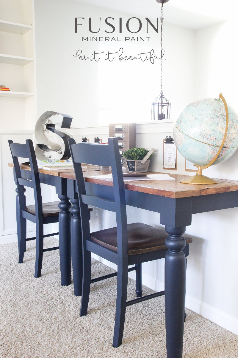 A wooden table and chairs, painted in Midnight Blue from Fusion Mineral Paint range with a world globe and S-shaped decor on the bare wood top