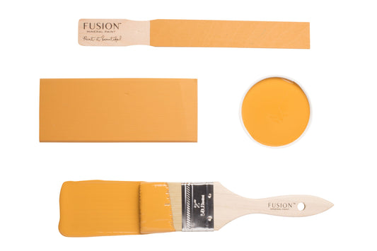 Fusion Mustard paint swatch with a brush on a white background