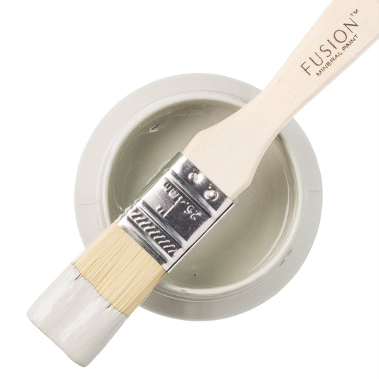 Fusion Mineral Paint in Parchment with a paintbrush resting on an open paint jar