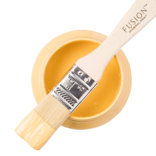 Fusion Mineral Paint in yellow Prairie Sunset with a paintbrush