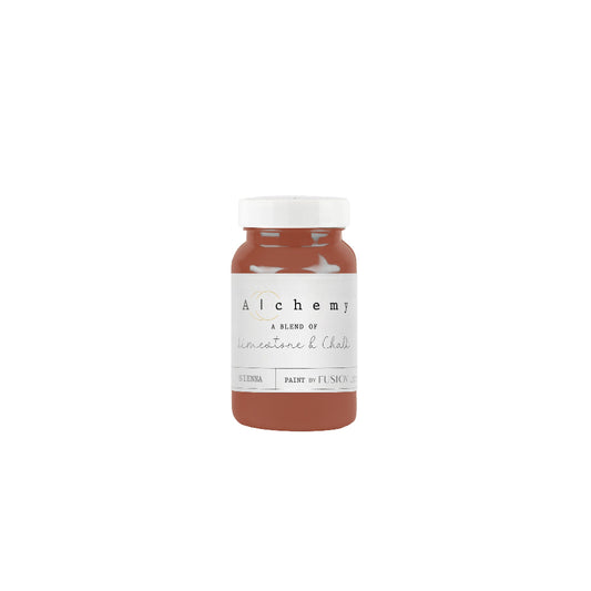 Bottle of Alchemy paint in earthy rust Sienna on a white background