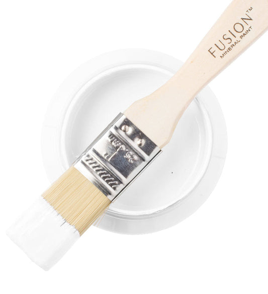 Fusion Mineral Paint brush with a container of paint labelled 'Snowdrop' on a white background