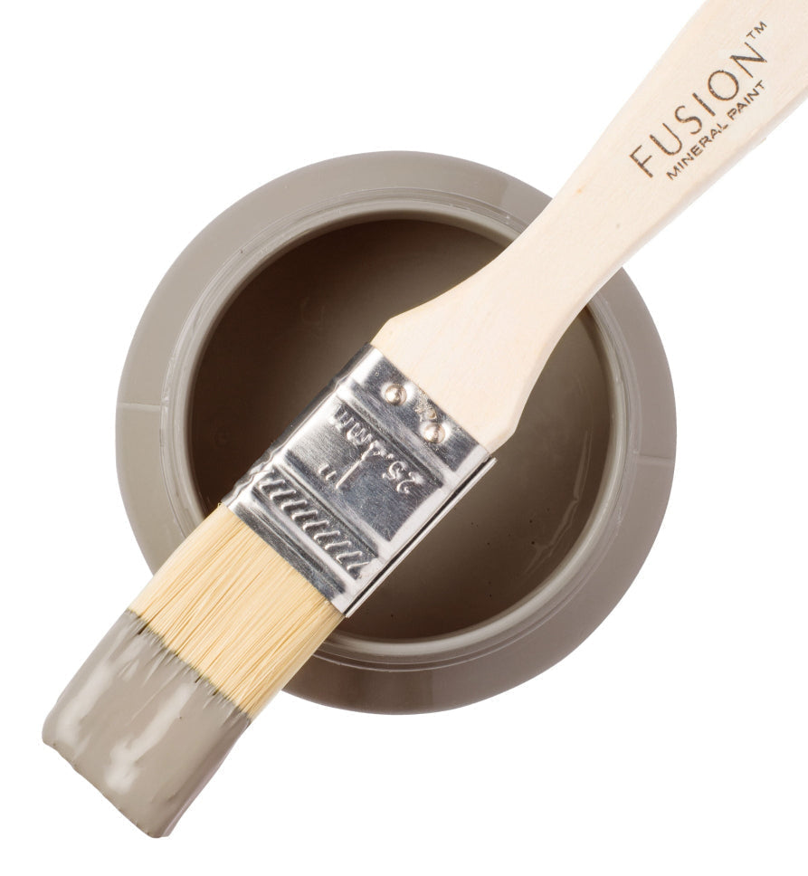 Fusion paint brush with a container of 'Tapestry' paint on a white background