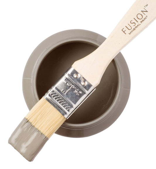 Fusion paint brush with a container of 'Tapestry' paint on a white background