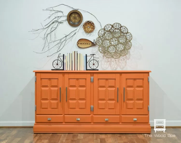 Cabinet painted in Tuscan Orange from Fusion Mineral Paint range with decorative items on a white wall