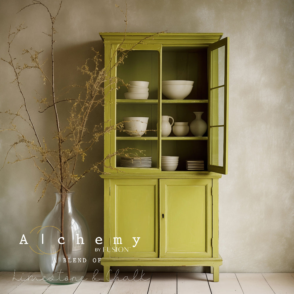Wooden cabinet painted in gorgeous greeny-mustard Willow from Alchemy by Fusion against a neutral wall