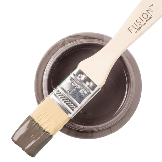 Paint brush dipped in brown Wood Wick from the Fusion Mineral Paint range on top of an open paint can