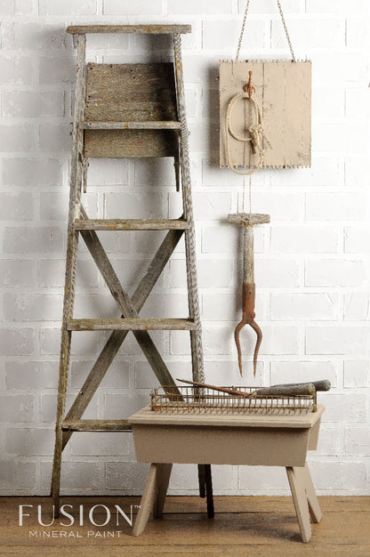 Wooden ladder and table painted in Algonquin from the Fusion Mineral Paint range against a white brick wall