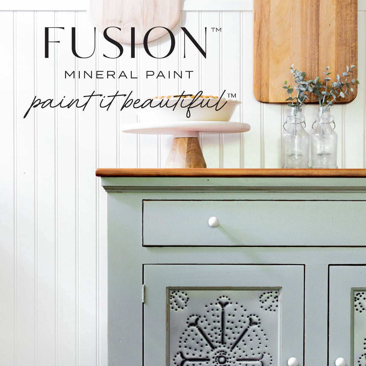 Light sage-coloured cabinet with decorative panel painted in Bellwood Fusion Mineral Paint. 