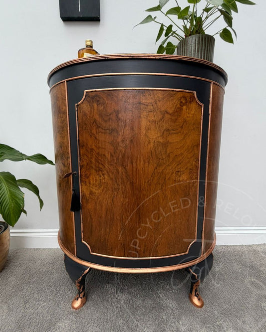 Upcycled bow fronted demi lune drinks cabinet in raw wood, Fusion Mineral Paint's Ash charcoal black with copper leaf accents on edges and Queen Anne feet. 