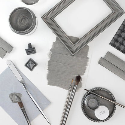 Collection of items including a frame, brushes, and containers painted in Fusion Metallics Brushed Steel on a white background