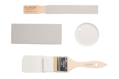 Fusion 'Cashmere' painted on colour swatches and paintbrushes on a white background