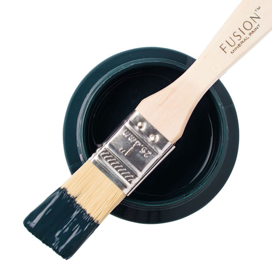 Fusion Mineral Paint in deep blue green Chestler on a paintbrush resting on a paint jar