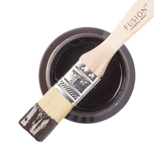 An open jar of Chocolate Brown Fusion Mineral Paint with a brush reting on t
