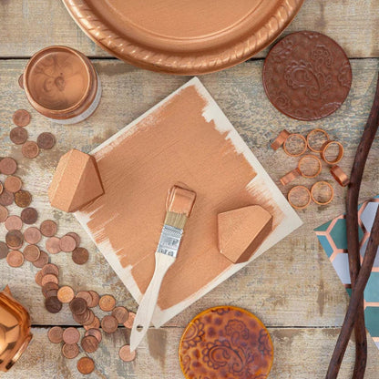 Decorative items including a paintbrush, decorative plates, and jars in Fusion Mineral Paints Metallic Bronze