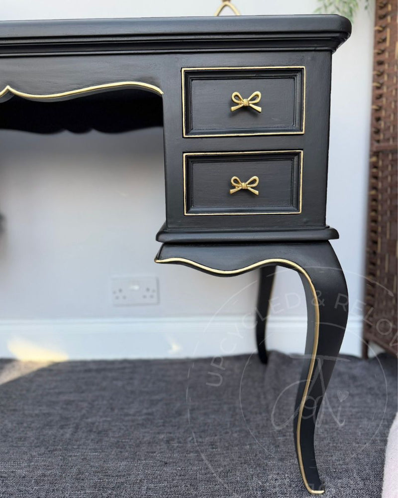 Close up of curved black dressing table leg and drawers with hand-painted gold detailing, transformed by Upcycled & Reloved by Jodi. 