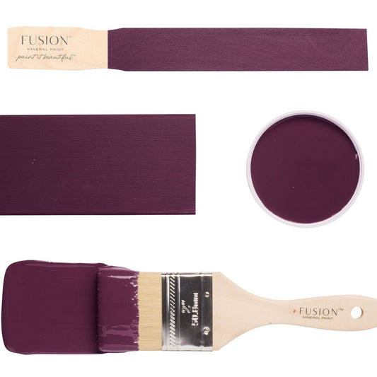 Paint swatches and brush dipped in Elderberry Fusion Mineral Paint on a white background