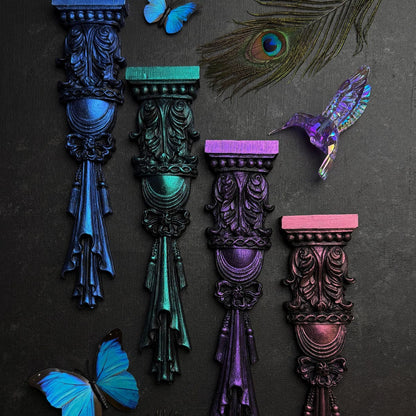 Decorative columns in various colours with butterflies and a peacock feather on a dark background, featuring Fusion Chromaflex Mineral Paint.