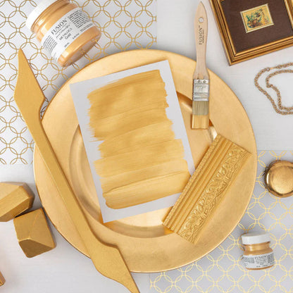 Decorative elements and paint swatches in Metallic Gold with a brush and Fusion Mineral Paint jar on a patterned surface