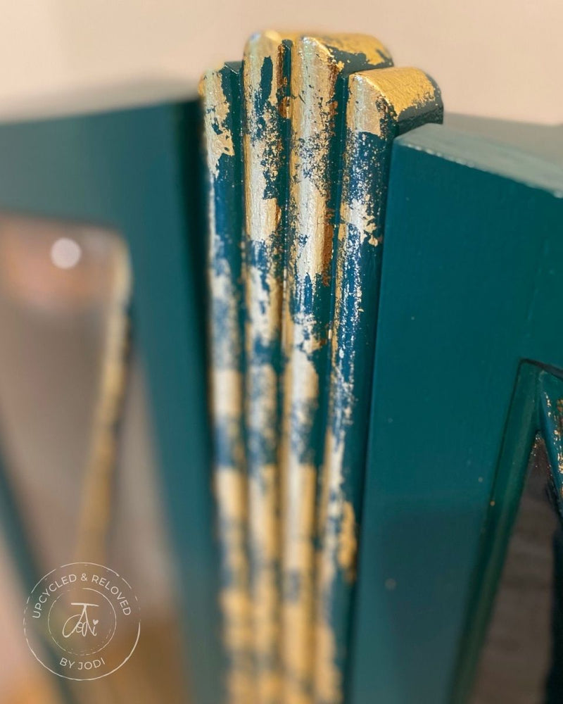 Close-up of a green and gold decorative element on an upcycled and reloved gin cabinet. 