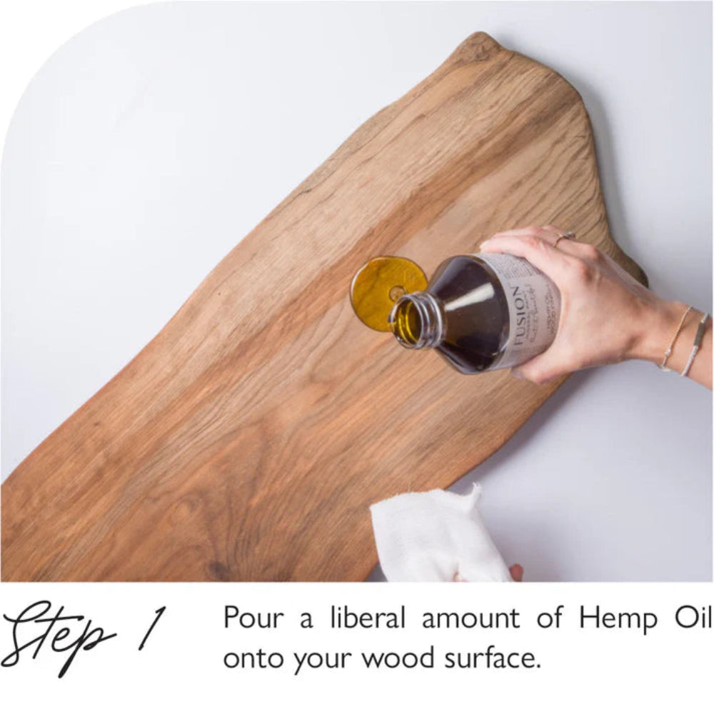 Person pouring Fusion Hemp Oil onto a wooden board