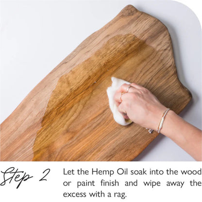Person applying Fusion Hemp Oil to a wooden surface.