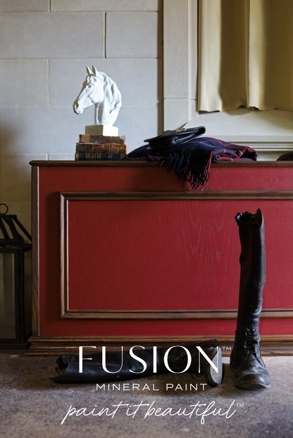 A cabinet painted in red Highlander from Fusion Mineral Paint range with a horse statue and riding boots