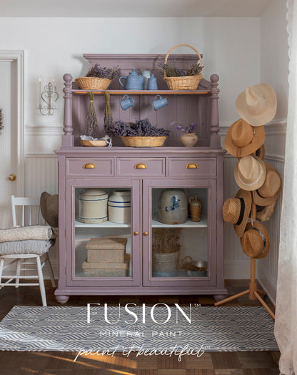Hutch painted in Lavender Haze from Fusion Mineral Paint range with decorative items in a room with hats on a rack