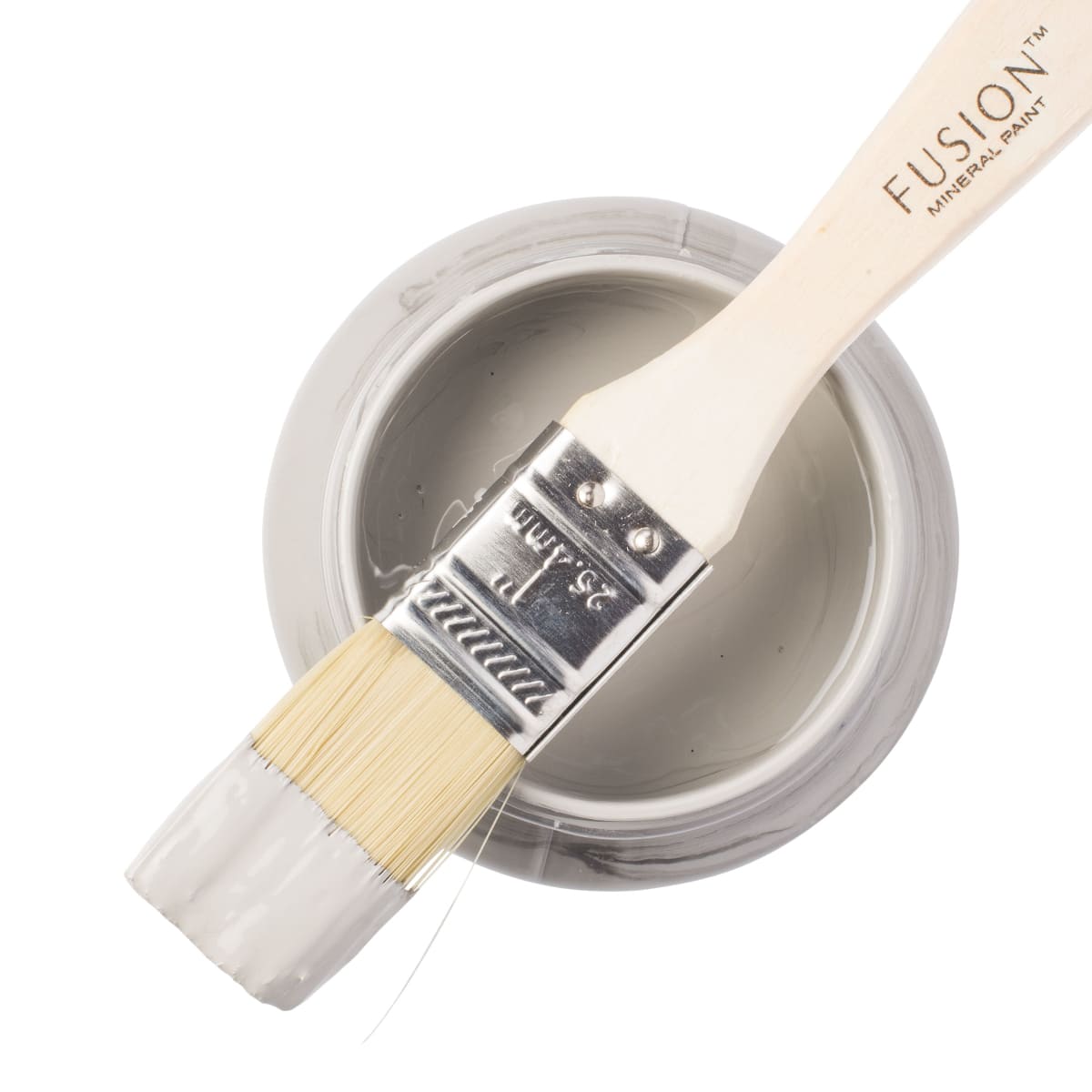 Fusion Mineral Paint in wooly grey Little Lamb on a paintbrush resting on a paint jar.