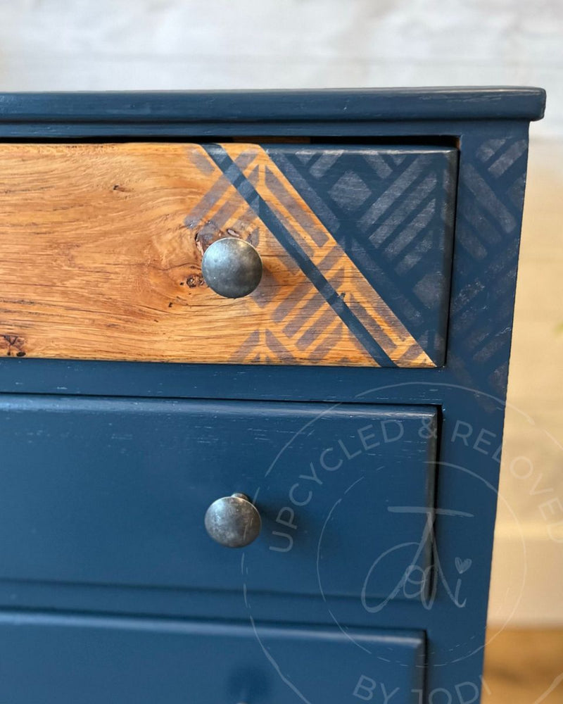 Navy and wood upcycled chest of drawers painted in Fusion Mineral Paint Willowbank with exposed wood grain and a silver wax geometric design.