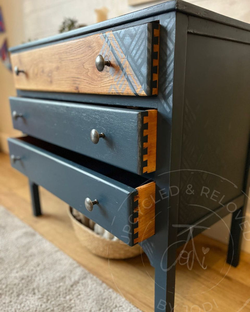 Drawer sides showing natural wood grain and painted dove tail joins on an upcycled navy chest of drawers by Upcycled & Reloved by Jodi. 