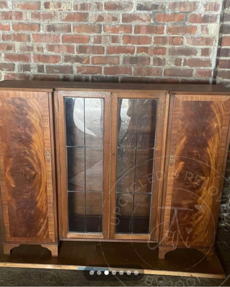 A large vintage wooden cabinet with glass doors and side cupboards before being transformed into a rum and drinks cabinet by Upcycled & Reloved by Jodi in Surrey, UK.