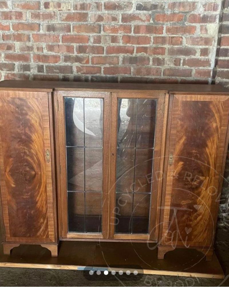 A large vintage wooden cabinet with glass doors and side cupboards before being transformed into a rum and drinks cabinet by Upcycled & Reloved by Jodi in Surrey, UK.