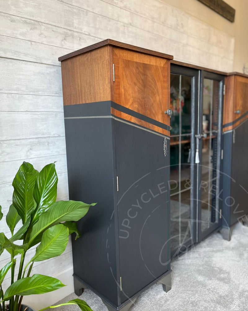 A side view of a large rum cabinet showing warm wood grain, Fusion Mineral Paint Ash and silver stripe detailing, refinished by Upcycled & Reloved by Jodi.