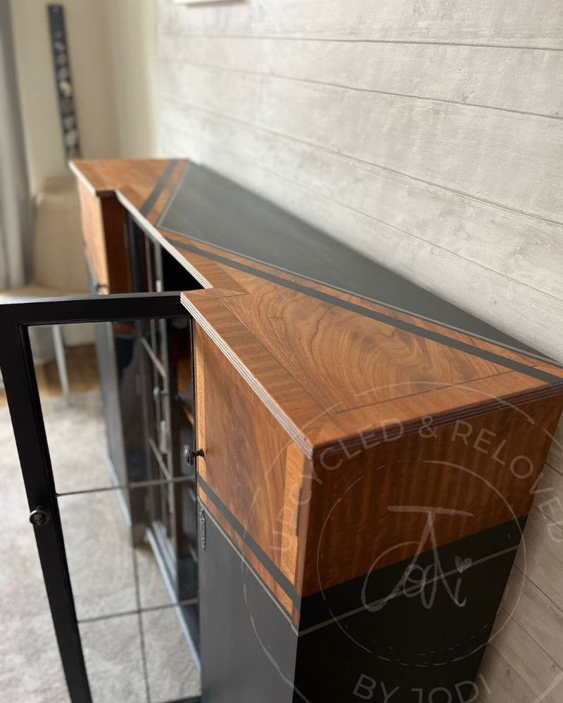 A close-up of the side cupboard on a large rum cabinet showing warm wood grain, Fusion Mineral Paint Ash and silver stripe detailing, restyled by Upcycled & Reloved by Jodi.